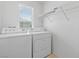 Bright laundry room featuring side by side washer and dryer and wire shelving at 10638 Pueblo Springs St, Las Vegas, NV 89183