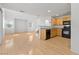 Open-concept living space includes hardwood floors and a kitchen area, perfect for modern living and entertaining guests at 10638 Pueblo Springs St, Las Vegas, NV 89183