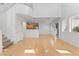 Spacious living room showcasing hardwood floors, a staircase, and multiple windows, creating a bright and open living space at 10638 Pueblo Springs St, Las Vegas, NV 89183