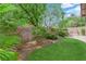 Lush backyard featuring trees, shrubs, and well-maintained artificial grass at 11237 Newbury Hills Ave, Las Vegas, NV 89138