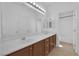 Bathroom featuring a double vanity, a large mirror, and a bathtub/shower, offering comfort and practicality at 11237 Newbury Hills Ave, Las Vegas, NV 89138
