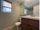 Well-lit bathroom featuring a modern vanity, a large mirror, and a walk-in shower enclosed with glass door at 11237 Newbury Hills Ave, Las Vegas, NV 89138
