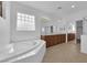 Bright bathroom offers a large soaking tub, double vanity and shower, a luxurious retreat for relaxation and comfort at 11237 Newbury Hills Ave, Las Vegas, NV 89138
