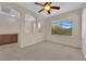 Open bedroom area with carpeted floors, a ceiling fan, and natural light at 11237 Newbury Hills Ave, Las Vegas, NV 89138