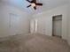 Bright carpeted bedroom with ceiling fan, closet, and neutral walls offers a comfortable retreat at 11237 Newbury Hills Ave, Las Vegas, NV 89138