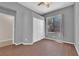 Bright bedroom with wood floors, closet, ceiling fan, and a large window at 11237 Newbury Hills Ave, Las Vegas, NV 89138
