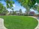 Expansive green space with lush grass and mature trees, perfect for outdoor activities at 11237 Newbury Hills Ave, Las Vegas, NV 89138