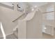 Elegant hallway with neutral paint, carpeted stairs, and distinctive architectural elements at 11237 Newbury Hills Ave, Las Vegas, NV 89138