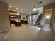 Open kitchen with granite countertops, stainless steel appliances, a center island, and staircase access at 11237 Newbury Hills Ave, Las Vegas, NV 89138