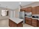 Gourmet kitchen with stainless steel appliances, center island, and warm wood cabinetry at 11237 Newbury Hills Ave, Las Vegas, NV 89138