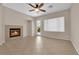 Bright, comfortable living room features tiled floor, fireplace, and door to the backyard at 11237 Newbury Hills Ave, Las Vegas, NV 89138