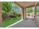 Covered patio area overlooking a well-maintained yard with lush green grass and landscaping at 11237 Newbury Hills Ave, Las Vegas, NV 89138