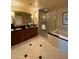 Bright bathroom featuring a separate shower and tub, double sinks, and updated fixtures at 135 E Harmon Ave # 518, Las Vegas, NV 89109