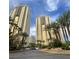 Stunning exterior view of modern high-rise buildings surrounded by lush palm trees and landscaped grounds at 135 E Harmon Ave # 518, Las Vegas, NV 89109