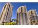 Three tall buildings with palm trees offer a resort-like atmosphere in a city setting at 135 E Harmon Ave # 518, Las Vegas, NV 89109