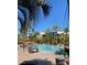 Inviting community pool surrounded by palm trees and lounge chairs on a sunny day at 135 E Harmon Ave # 518, Las Vegas, NV 89109