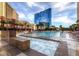 Inviting swimming pool with a hot tub and comfortable lounge chairs at 135 E Harmon Ave # 518, Las Vegas, NV 89109