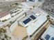 Aerial view of a home featuring solar panels, landscaping, and a large driveway at 1409 Denver St, Boulder City, NV 89005