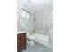 Contemporary bathroom featuring a tub/shower combo and marble-style tile at 1409 Denver St, Boulder City, NV 89005
