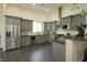 Gray kitchen with stainless steel appliances, granite counters, and wood-look floors at 1409 Denver St, Boulder City, NV 89005