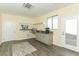 Bright laundry room with gray cabinets, granite countertop, and stainless steel faucet at 1409 Denver St, Boulder City, NV 89005