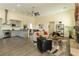 Open-concept living area with modern kitchen, stone fireplace, and stylish furniture in a naturally lit space at 1409 Denver St, Boulder City, NV 89005