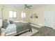 Bright main bedroom with three windows and a ceiling fan at 1409 Denver St, Boulder City, NV 89005