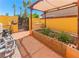 Backyard garden area featuring garden beds, outdoor equipment, covered patio, and fence at 1440 Rawhide Rd, Boulder City, NV 89005