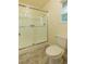 This bathroom features a glass-enclosed shower stall, a toilet, and a window at 1440 Rawhide Rd, Boulder City, NV 89005