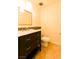 Bathroom with a single vanity with tiled backsplash, tiled floors and a toilet at 1440 Rawhide Rd, Boulder City, NV 89005