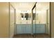 Modern bathroom with double sink vanity, mirrored closet and a door at 1440 Rawhide Rd, Boulder City, NV 89005