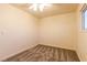 Well-lit bedroom with a ceiling fan and comfortable carpeting at 1440 Rawhide Rd, Boulder City, NV 89005