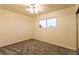 This bedroom has neutral carpet, a ceiling fan, and a window at 1440 Rawhide Rd, Boulder City, NV 89005