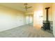 Bedroom with carpet, ceiling fan, full mirror closet, an entrance to a bathroom and a black fireplace at 1440 Rawhide Rd, Boulder City, NV 89005