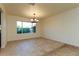Bright dining room with tile floors, chandelier, and large window with backyard views at 1440 Rawhide Rd, Boulder City, NV 89005