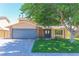Inviting two-story home with stone accents and a blue garage door at 1440 Rawhide Rd, Boulder City, NV 89005
