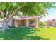 Landscaped front yard with mature trees and inviting curb appeal at 1440 Rawhide Rd, Boulder City, NV 89005
