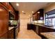 Elegant kitchen with stainless steel appliances, granite countertops, and custom wood cabinetry and views of backyard at 1440 Rawhide Rd, Boulder City, NV 89005