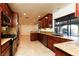 Well-lit kitchen with stainless steel appliances, granite countertops, custom wood cabinets, and tile flooring at 1440 Rawhide Rd, Boulder City, NV 89005