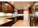 Modern kitchen featuring custom cabinets, granite countertops, stainless steel appliances, and tile flooring at 1440 Rawhide Rd, Boulder City, NV 89005