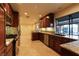 Spacious kitchen featuring stainless steel appliances, granite countertops, custom wood cabinets and tile flooring at 1440 Rawhide Rd, Boulder City, NV 89005