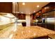Bright kitchen featuring granite countertops, stainless steel appliances, and custom cabinets in a well-lit setting at 1440 Rawhide Rd, Boulder City, NV 89005