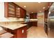 Eat-in kitchen with granite countertops, a bar, stainless steel appliances, and custom cabinets with glass inserts at 1440 Rawhide Rd, Boulder City, NV 89005