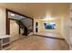 Tiled living room showcases the staircase, open floor plan, and natural light from window at 1440 Rawhide Rd, Boulder City, NV 89005