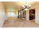 Bright open floor plan with tiled floors, chandelier, and stairs to upper level at 1440 Rawhide Rd, Boulder City, NV 89005