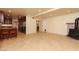 Open concept living room with kitchen bar, fireplace, and tile flooring at 1440 Rawhide Rd, Boulder City, NV 89005