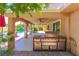 Outdoor kitchen featuring a stainless steel grill, under a covered patio with decorative columns overlooking the pool area at 1440 Rawhide Rd, Boulder City, NV 89005