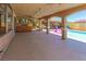 A covered patio that overlooks a sparkling pool and lush landscaping, creating a serene outdoor retreat at 1440 Rawhide Rd, Boulder City, NV 89005