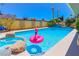 Sparkling pool with a flamingo floatie is set against a lush backdrop, perfect for enjoying sunny days at 1440 Rawhide Rd, Boulder City, NV 89005