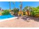 Beautiful pool and brick patio surrounded by mature landscaping, perfect for outdoor entertaining and relaxation at 1440 Rawhide Rd, Boulder City, NV 89005